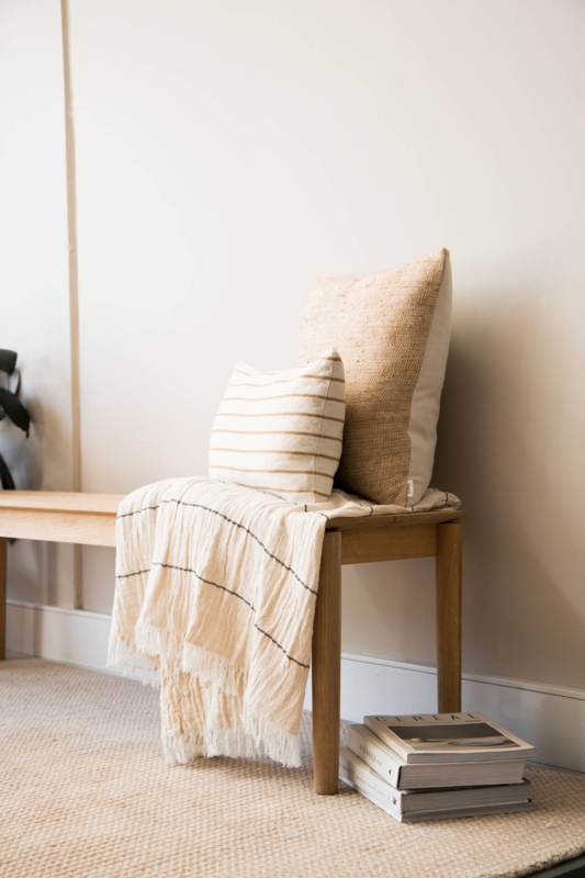 Cozy Neutral Throw Pillows on Wooden Bench