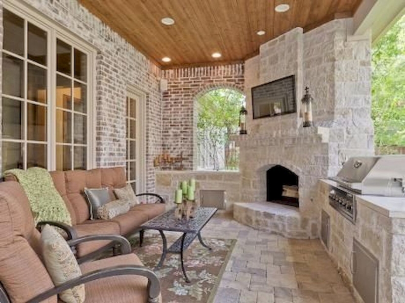 Cozy Outdoor Corner Fireplace with Built-in Grill