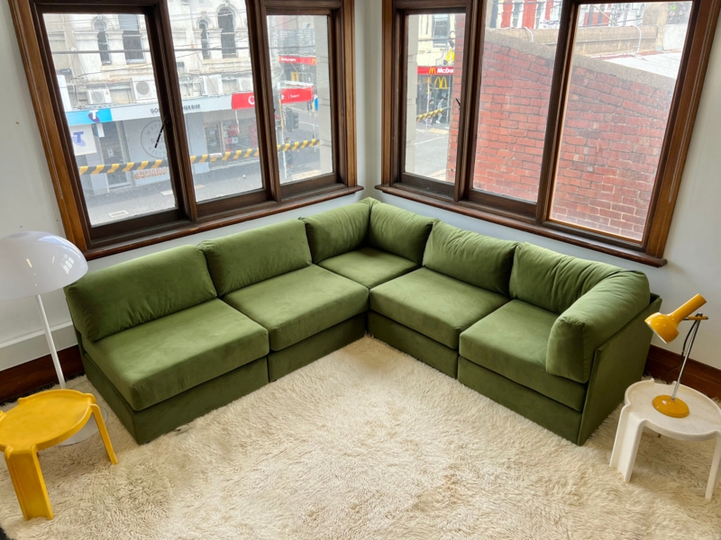 Green Modular Sectional Sofa in Corner Living Room