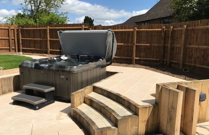 Modern Outdoor Hot Tub Surrounded by Wood and Stone