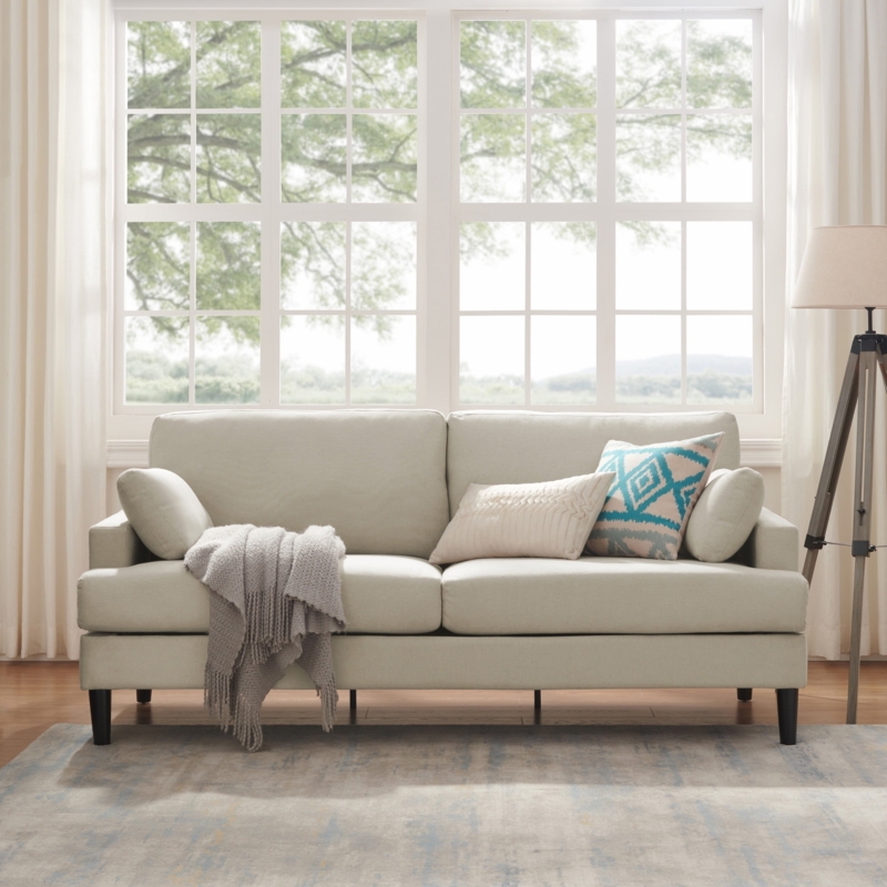 Oatmeal Sofa with Patterned Pillows and Cozy Throw