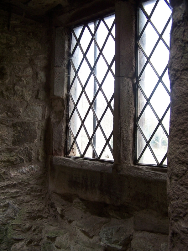 Rustic Latticed Windows in Stone Wall