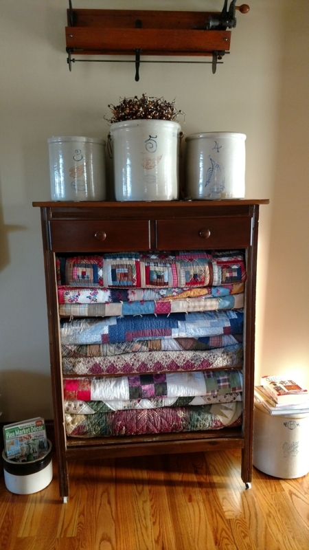 Vintage Quilt Storage in Wooden Cabinet