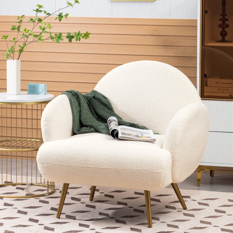 Accent Chair featuring white boucle upholstery and gold tapered legs.