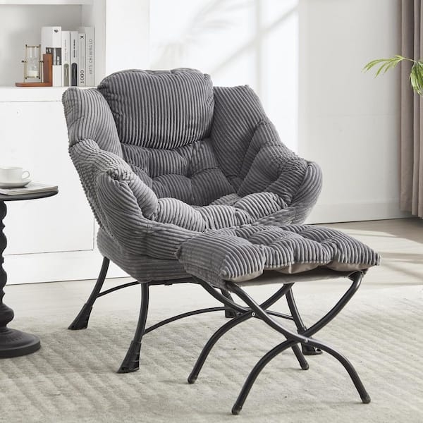 Accent Chair in grey corduroy fabric with matching ottoman and tufting.