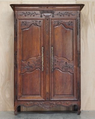 Antique Carved Armoire featuring Hand-Carved Floral Motifs and Scalloped Apron.