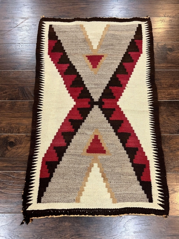 Area Rug with Crimson Hourglass Motif and Sawtooth Border
