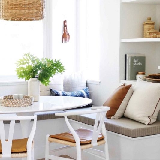 Banquette Seating with Woven Pendant and White Wishbone Chairs