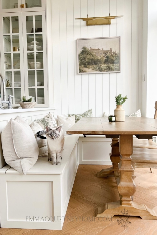 Breakfast Nook with Glass Front Cabinets and Herringbone Wood Floor