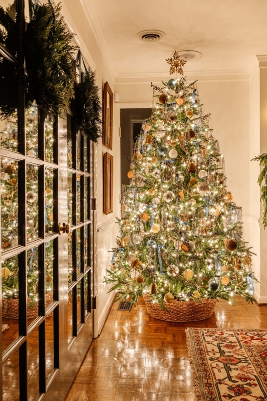 Christmas Tree with Wicker Collar in Traditional Hallway Holiday Decor