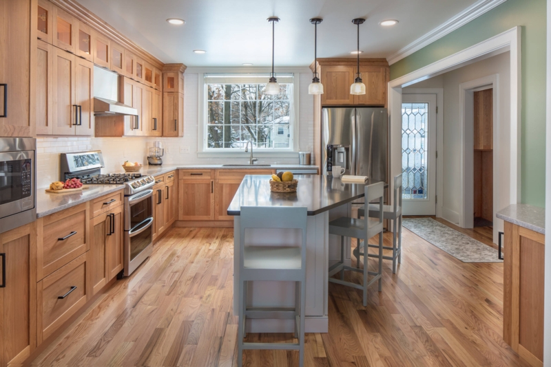 Contrasting Kitchen Island with Gray Wood Stools & Glass Pendants