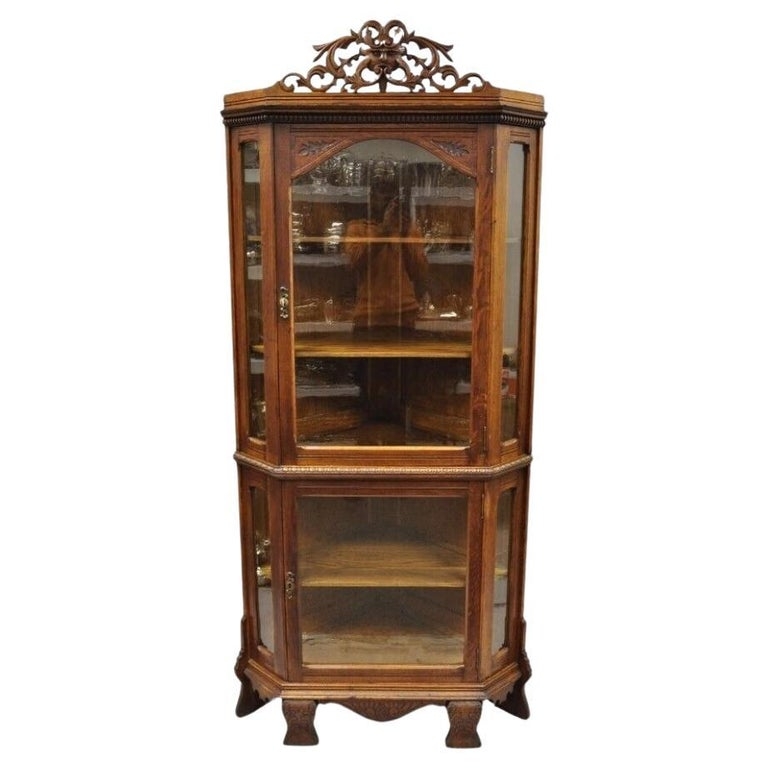 Corner Cabinet featuring Ornate Scroll Crest and Carved Feet
