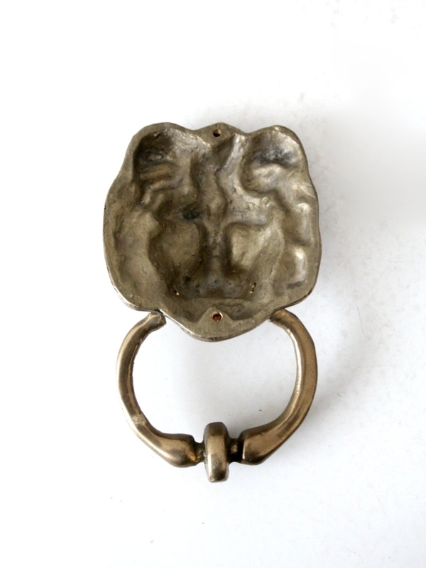 Door Knocker, Weathered Brass Lion Head with Sand Cast Texture.