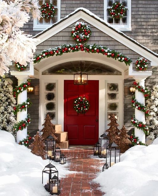 Exterior Entryway with spiraled column garlands and red front door garland.