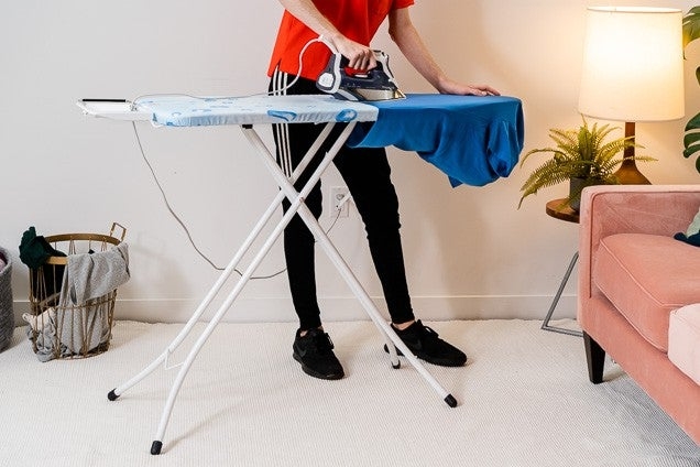 Folding Ironing Board with Blue Patterned Cover and Integrated Rest