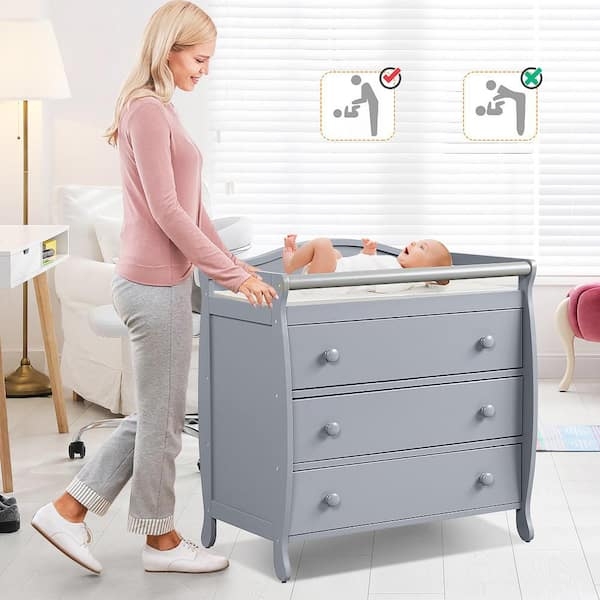 Grey Baby Changing Table with Curved Side Panels and Safety Guardrail.