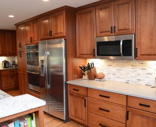 Kitchen Cabinets with Black Linear Pulls and Mosaic Backsplash
