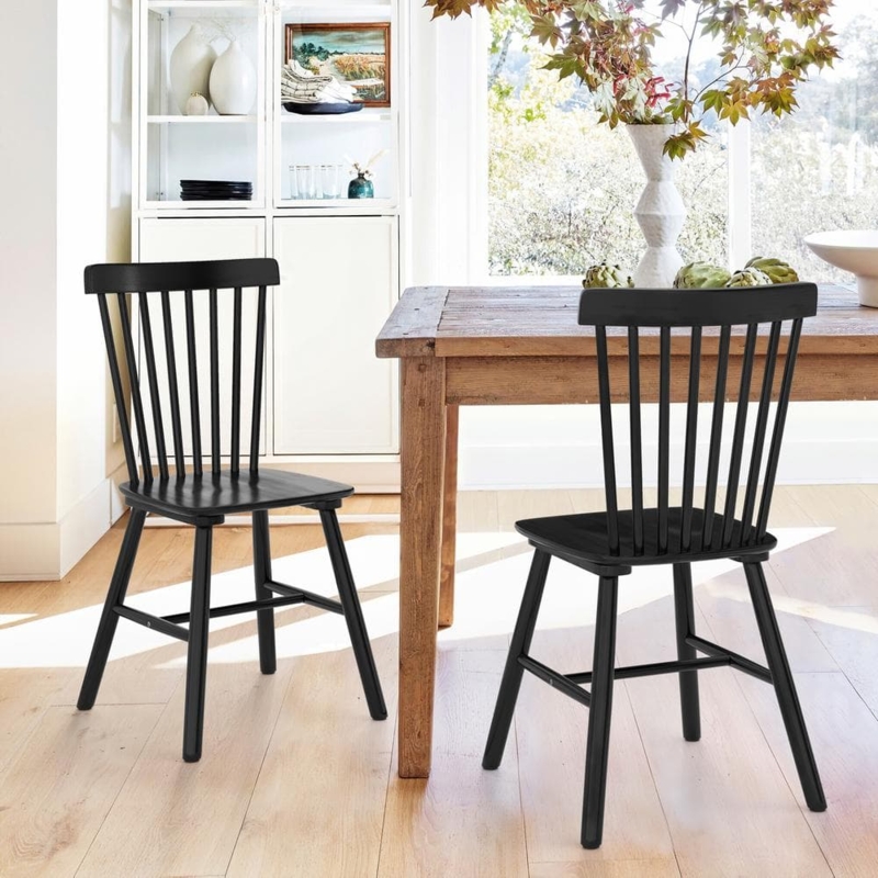 Matte Black Dining Chair with Curved Top Rail and Spindle Back Design.