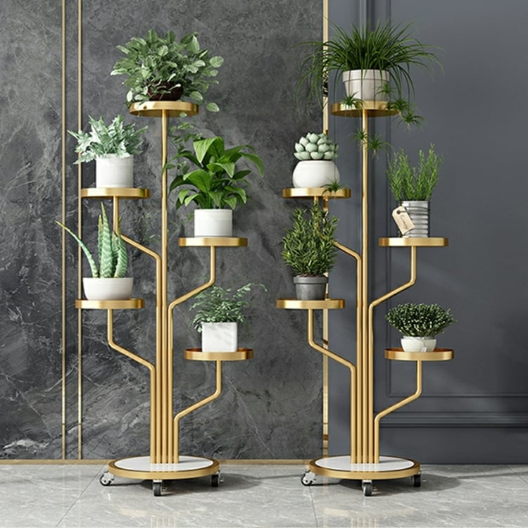 Multi-Tier Mobile Flower Rack with Gold Finish and Branch Design.