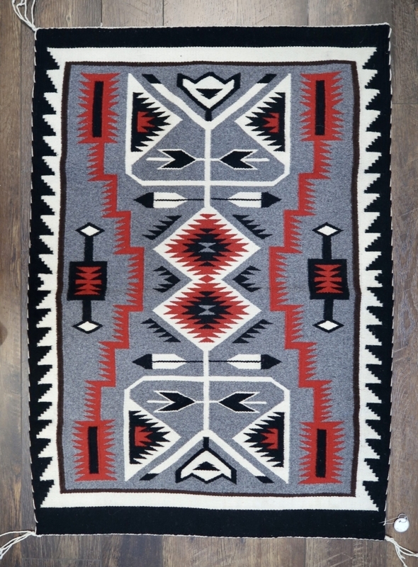 Navajo Rug Storm Pattern with Vibrant Red Geometric Arrows
