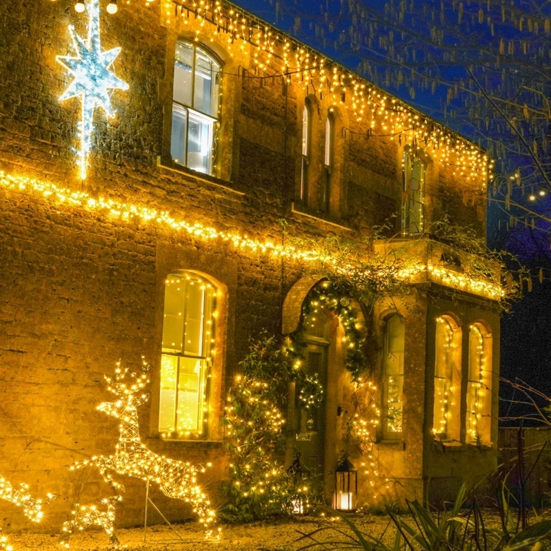 Outdoor Holiday Decor: Wireframe reindeer, icicle lights, illuminated star.