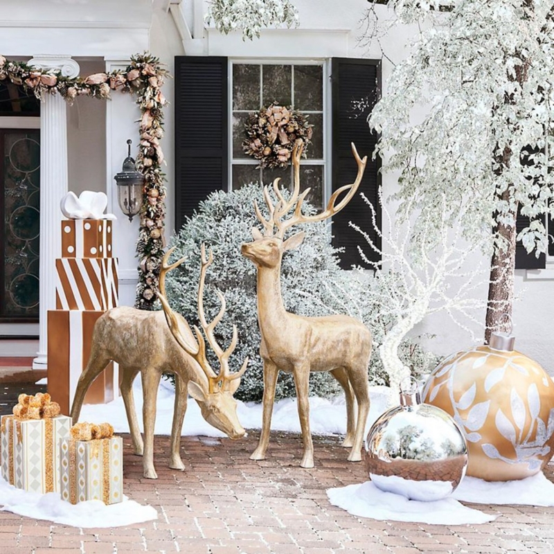 Outdoor Holiday Display: Oversized gold reindeer, metallic ornaments.