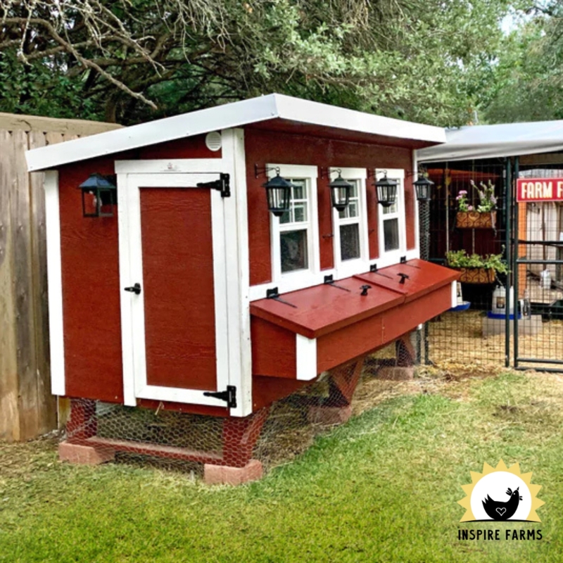 Red Farmhouse Chicken Coop with Wall Mounted Lanterns and Triple Windows