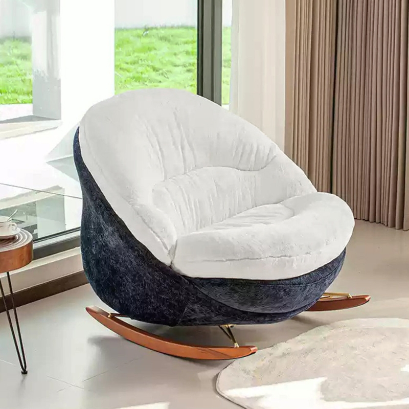 Rocking Chair with a cocoon seat, navy/white plush, and gold struts.