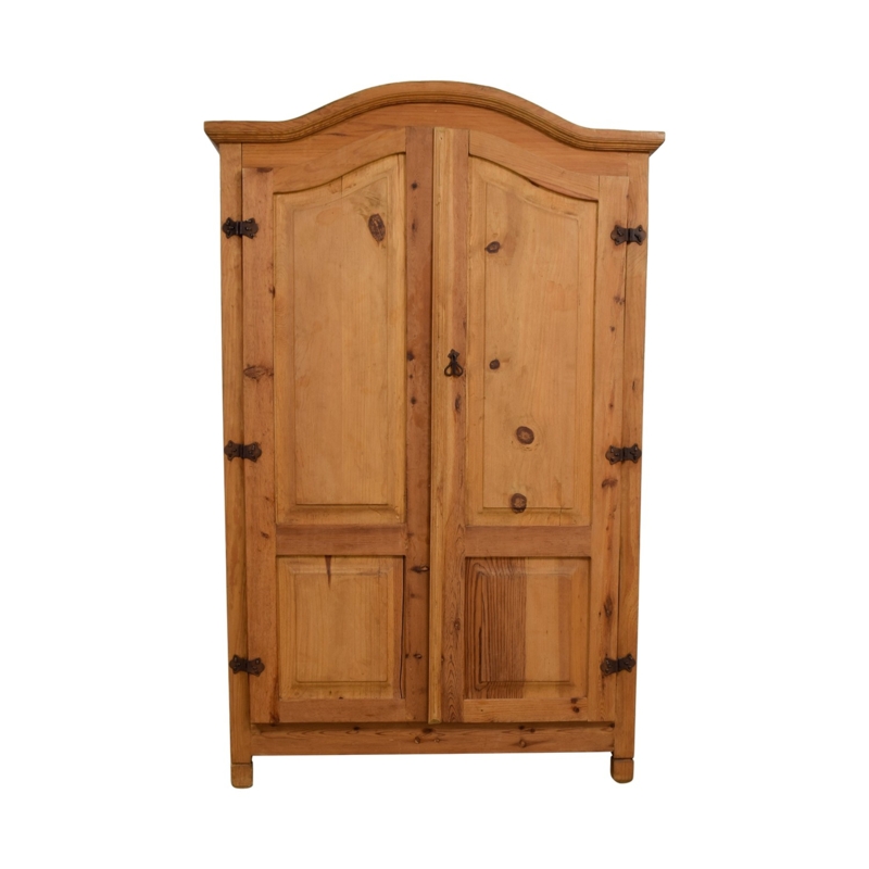 Rustic Farmhouse Armoire with Arched Top and Exposed Iron Hinges.