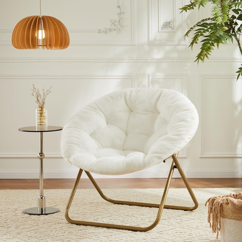 Saucer Chair boasting a tufted seat; a tufted round folding chair.
