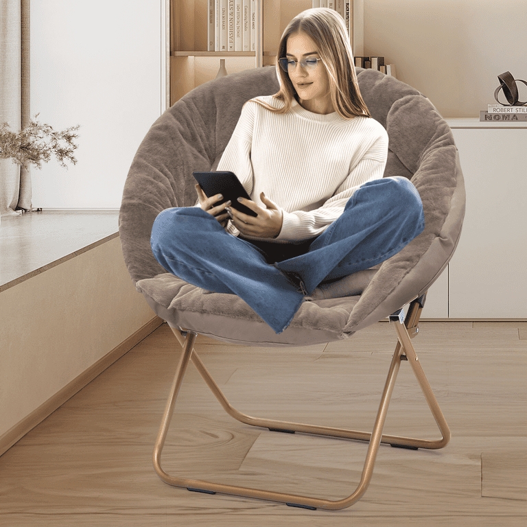 Saucer Chair featuring an oversized moon shape and beige faux fur.