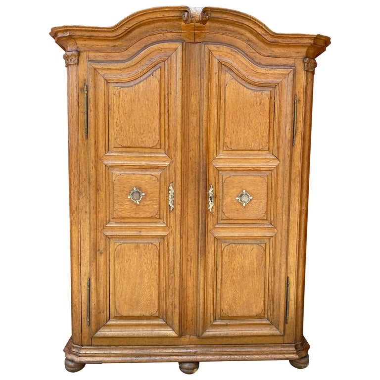 Solid Oak Armoire with Arched Cornice and Distinctive Long Exterior Hinges.