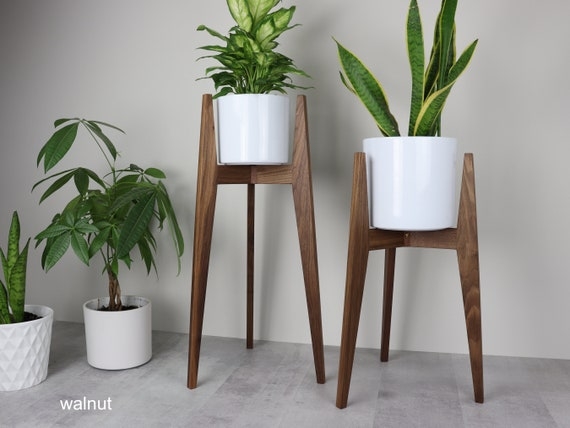Walnut Tripod Plant Stand with Tapered Legs for Minimalist Decor.