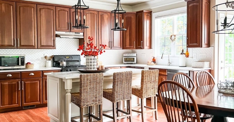White Kitchen Island with Woven Rattan Bar Stools and Wood Cabinets