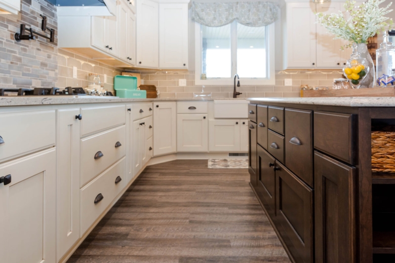 Antique Ivory Shaker Cabinets with Dark Wood Island and Farmhouse Sink