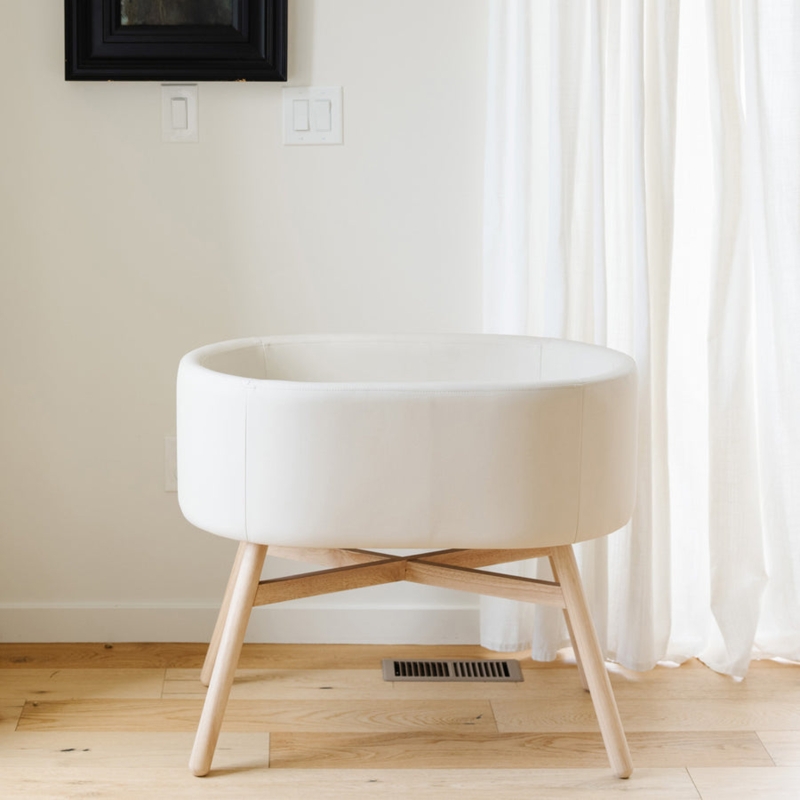 Bassinet Capsule Shape Ivory Upholstery X-Frame Base Tapered Legs