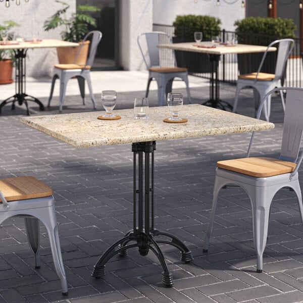 Bistro Table: Kashmir White Granite Top, Four-Legged Base, Industrial Style.