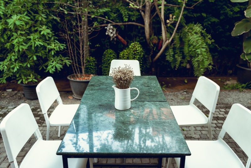 Dining Table: Polished Forest Green Stone, White Contrast Seating, Modern.