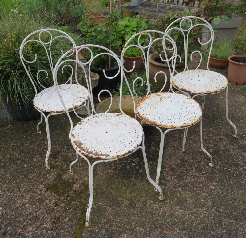 Distressed White Garden Chairs with Perforated Seats and Scrollwork Backs