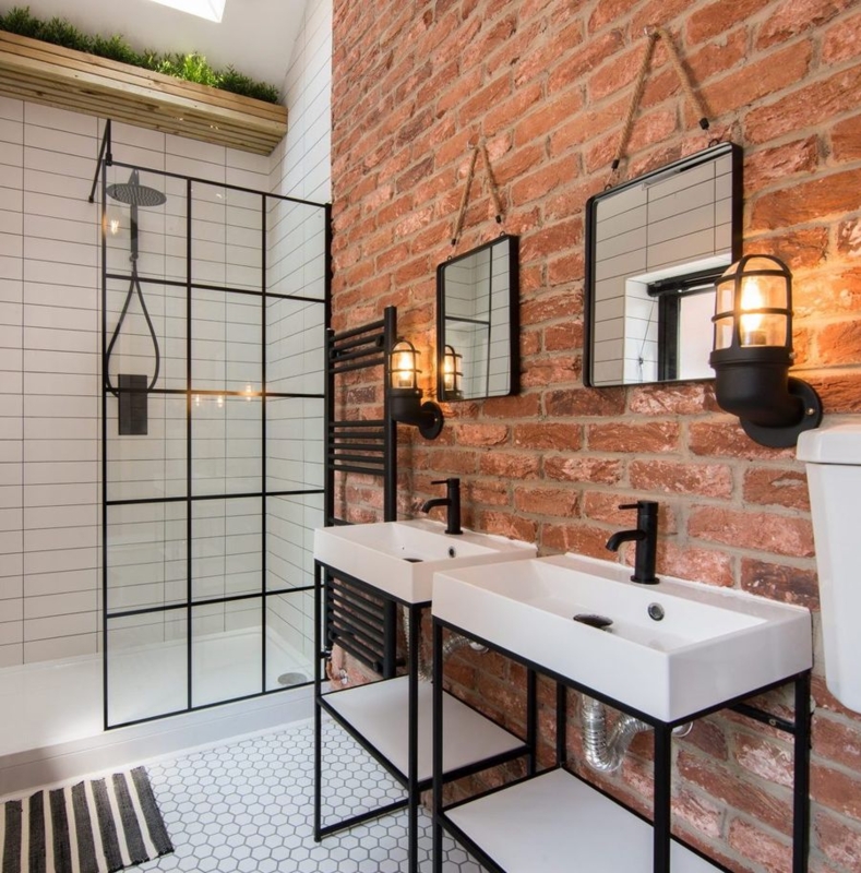 Double Vanity: Features Rope Hung Mirrors against an Exposed Brick Wall