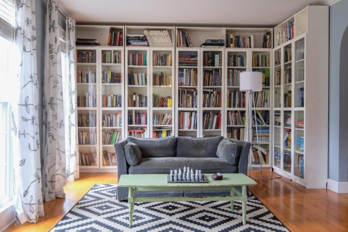 Floor-to-Ceiling White Bookshelves in Transitional Home Library