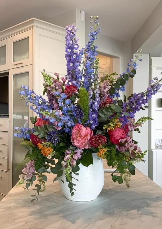 Flower Arrangement: Tall Vertical Delphinium Spikes in White Bulbous Vase