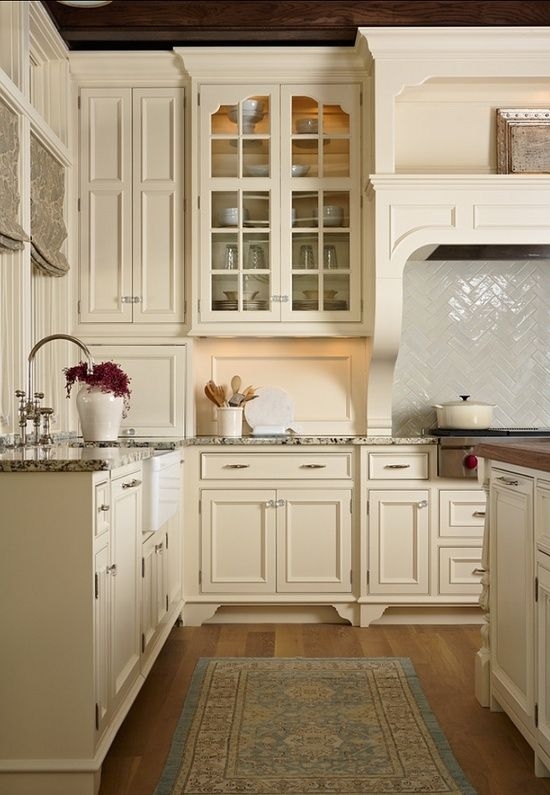 Ivory Cabinets with Herringbone Backsplash and Custom Mantle Hood