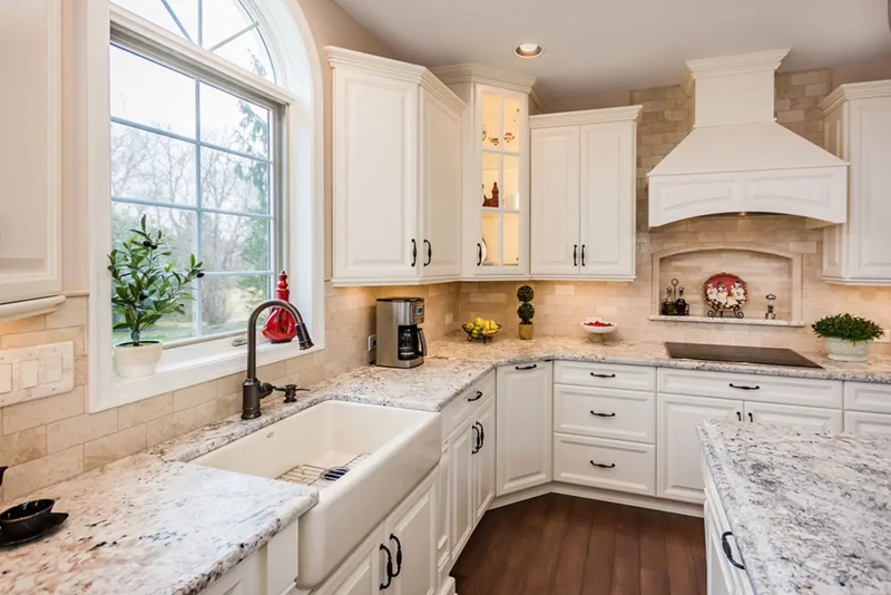 Ivory Raised Panel Cabinets with Farmhouse Sink and Bronze