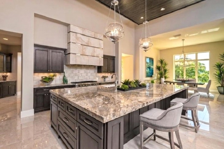 Kitchen Island with Heavily Patterned Stone and Globe Pendant Lights