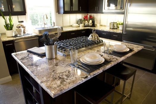 Kitchen Island with Integrated Gas Cooktop and Veined Stone Surface