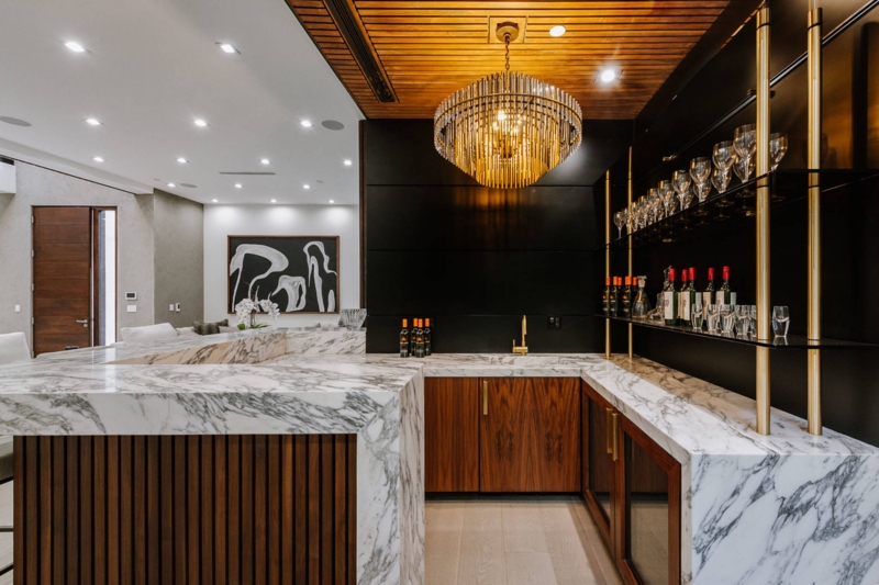 Luxury Home Bar with Marble Waterfall Edge & Crystal Rod Chandelier