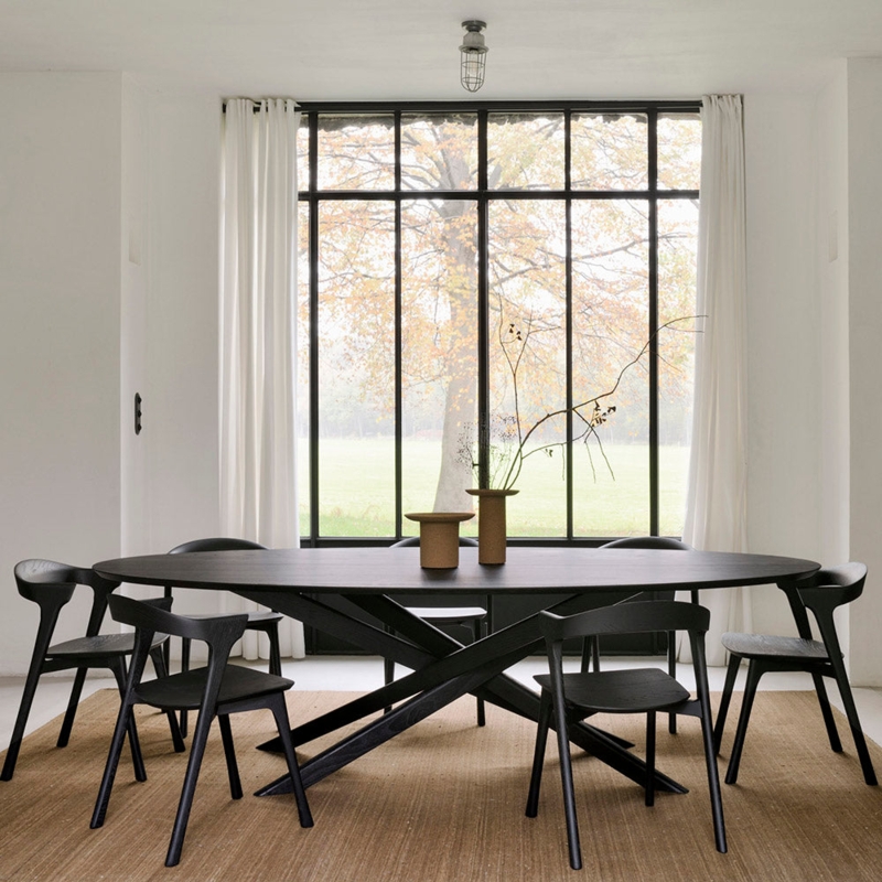 Matte Black Oval Dining Table featuring a Modern Interlocking Base