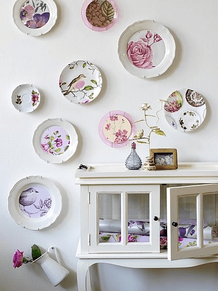Mismatched Floral Plate Display Wall above Scalloped Sideboard Cabinet
