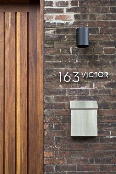 Modern Industrial Entryway: Vertical Slat Door, Brushed Metal Mailbox